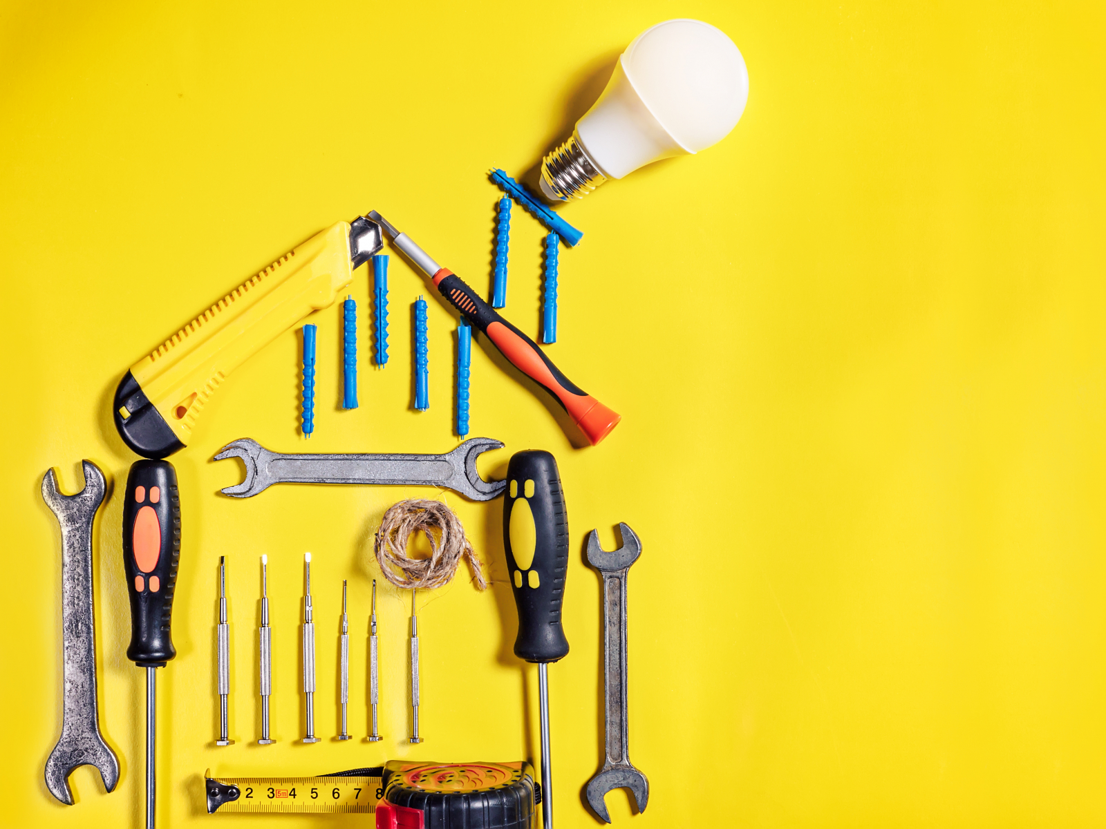 Tools hanging on yellow wall