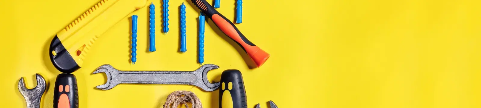 Tools hanging on yellow wall